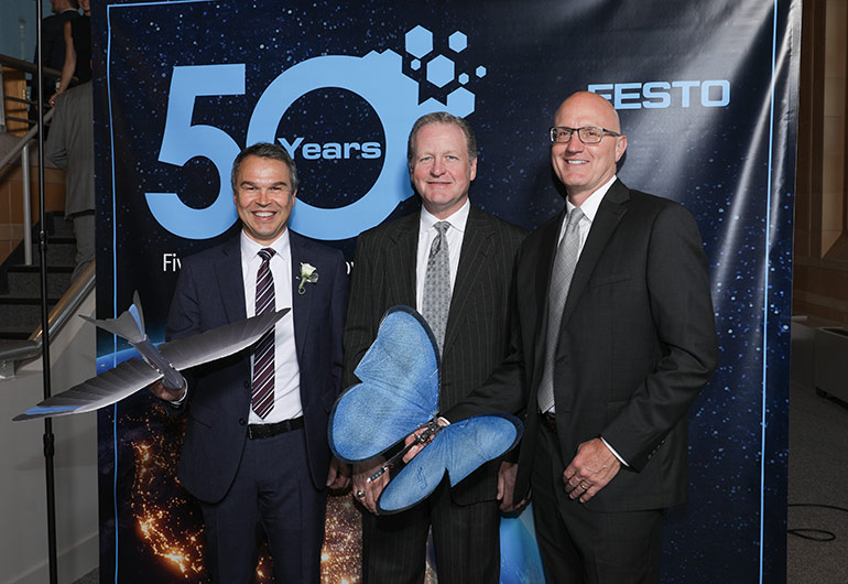 Most of the more than 100 guests at the Festo 50th Anniversary Gala held in Cincinnati had their pictures taken with the Bionic Swift and Butterfly – Festo flying robots modeled after nature. From left to right: Frank Notz, Festo Management Board Member; Bill Gerbig, President of Ralph W. Earl; and Mark Snyder, Director of Festo North America Channel Management.