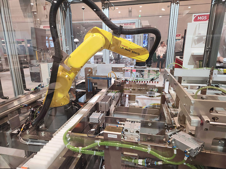 The Fanuc robot here is paired with a variety of Festo pneumatic valves and actuators to allow for lifting, gripping, rotating, and more.