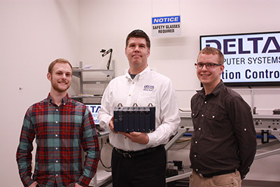 From left to right, David McNichol, Aaron Heinrich and Paul Huumala. Heinrich holds Delta’s new RMC200 motion controller product.