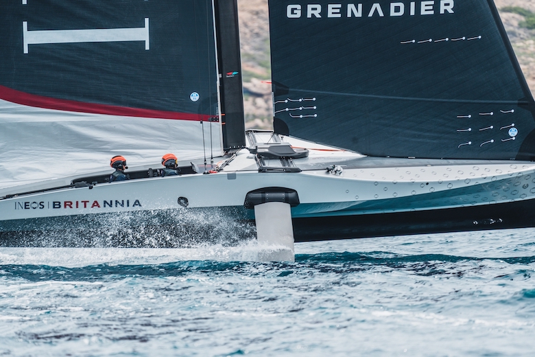 The INEOS Britannia race boat speeding on the water.