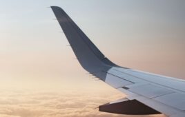 Airplane wing over clouds.