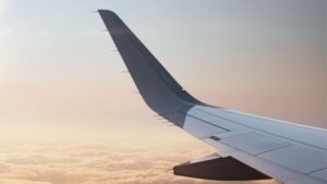 Airplane wing over clouds.