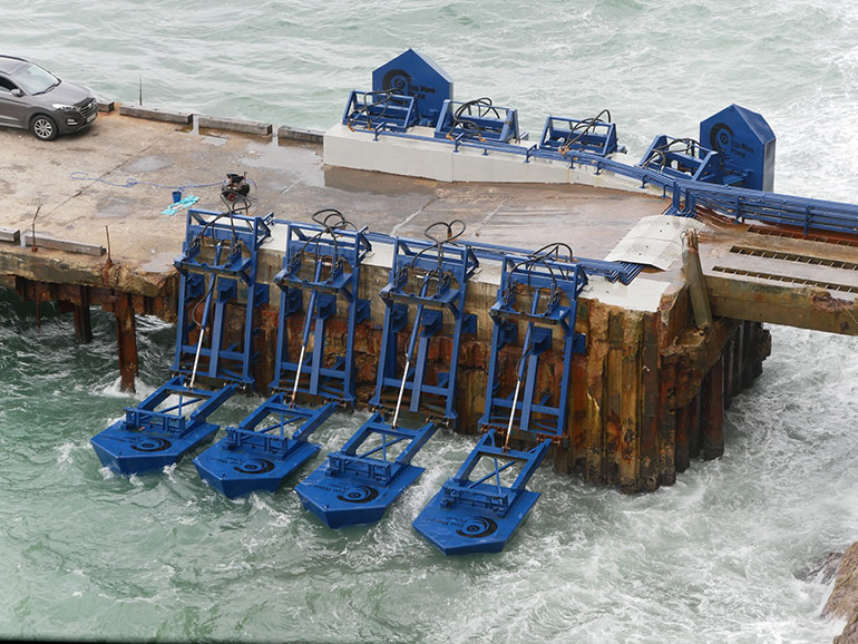 During operation, buoyant “floaters” harvest energy by converting the rising and falling motion of incoming waves. Floater motion extends and retracts hydraulic cylinder pistons which, in essence, act as linear pumps. Courtesy of Eco Wave Power 