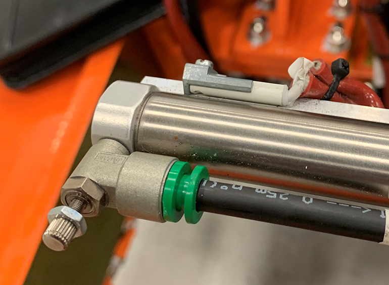 Festo PM tubing utilizes standard push connectors (green center) for fast, lower cost installs compared to laminated tubing. The sleek aluminum tube requires minimal space.