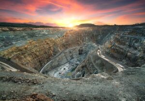 An active mining quarry juxtaposed against a beautiful sunset.