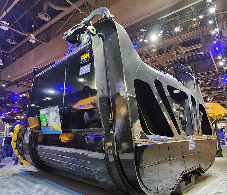 Hydraulic snubbers, seen at the top front, are used to control the opening and closing of the dipper doors on mining bucket shovels. Pictured here is one such dipper bucket from P&H. The snubber pictured is an original OEM design and not Open Loop Energy's HydroSnubs.