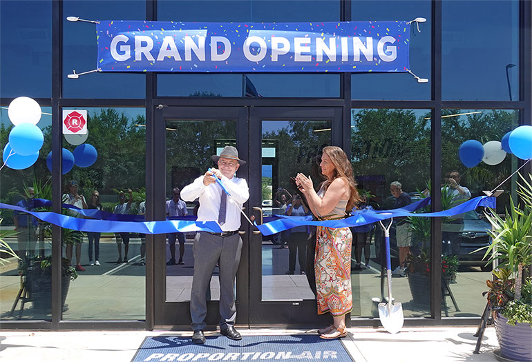 Proportion-Air's CEO and founder David Cook cuts the ribbon at the company's new Gulf Breeze, Florida, facility.