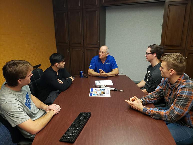 Purdue Team 16 Cook Capstone 2023: During the team’s visit to the factory, Proportion-Air President Dan Cook (center), offers some ideas to Purdue Polytechnic Institute Team 16 for improving their capstone project. From left: TJ Manifold, Nico Macchiavello, Cook, Jacob Nicholson and Ian Cockrell. The team is developing an acoustic position sensor.