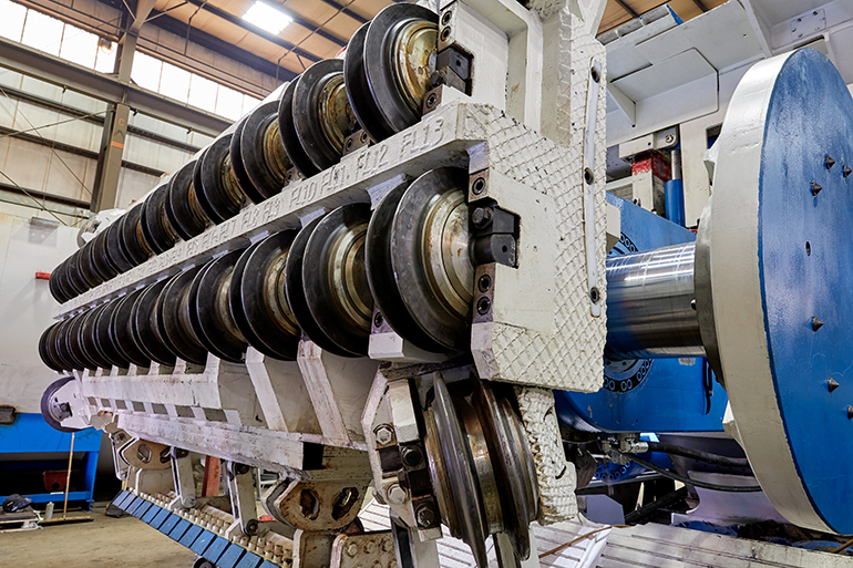 Hydraulic cylinders on a TBM push disc cutters into the rock face. High thrust through the rolling cutters fractures the material. 