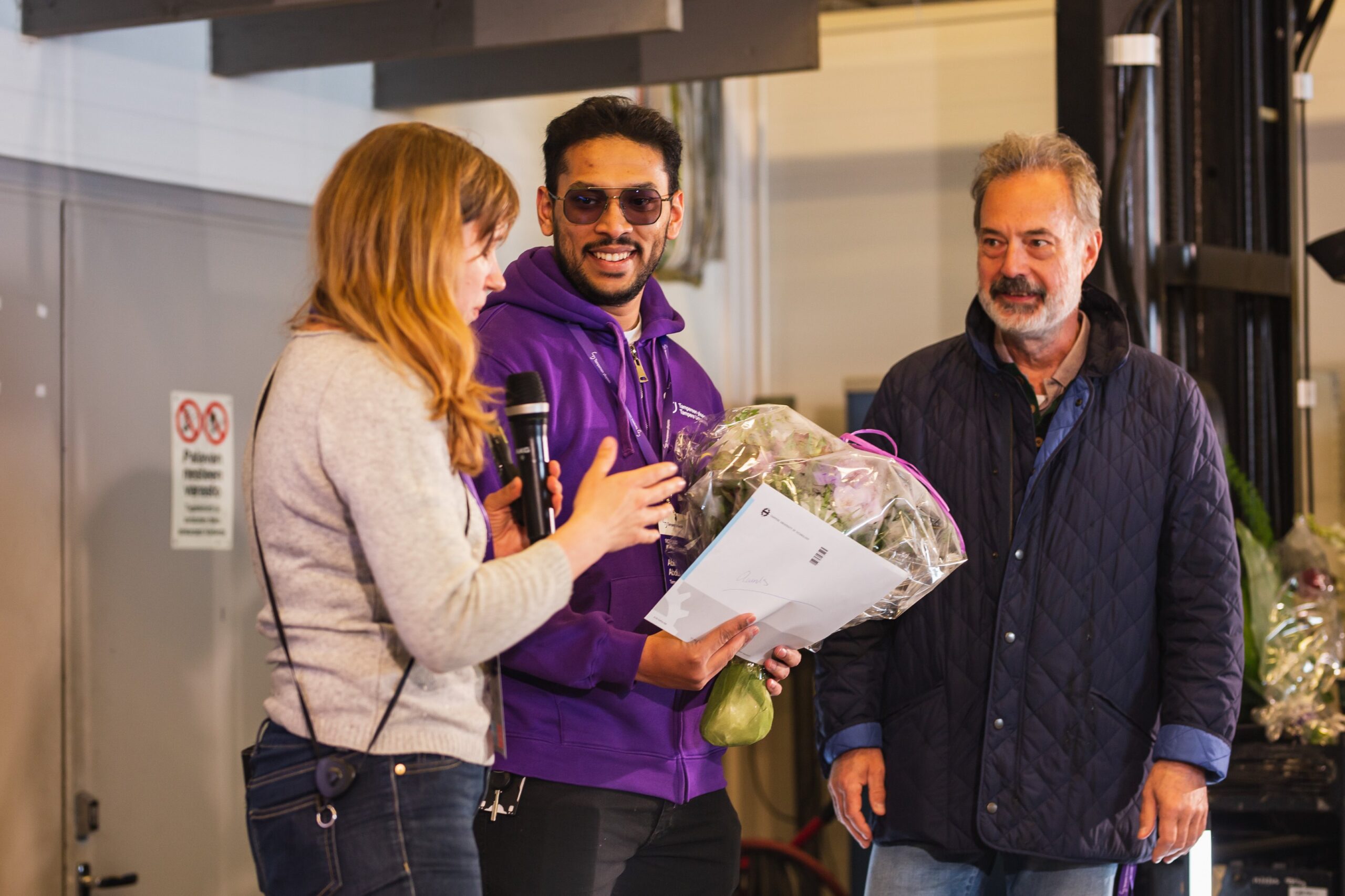 Abid Abdul Azeez (center) accepts the Best Presentation Award at SICFP 2023.