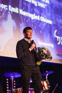 Emil Nørregård Olesen speaking at the SICFP 2023 gala after winning Best Paper Award.