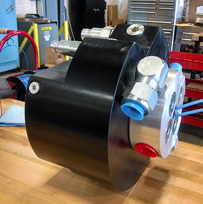 A custom rotary union designed by Turner Hydraulics/TASCorp. features four ports of hydraulic fluid transmission — a pressure line, tank line, drain or pilot operating line, and second pressure or tank line.   | Courtesy of Turner Hydraulics/TASCorp.