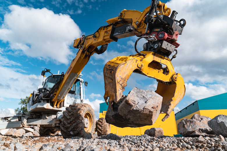 Autonomous hydraulic excavator building a stone wall.